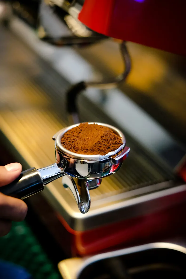 On demand coffee grinder beside an espresso machine