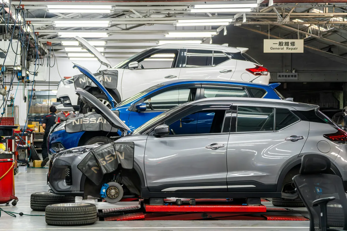 Workshop vehicles positioned on professional servicing lifts